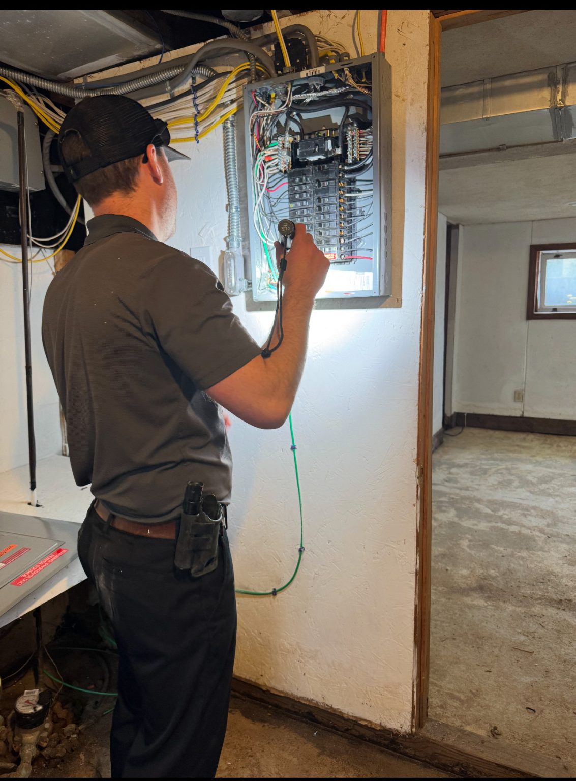 Professional home inspector performing an electrical inspection in Clinton MA